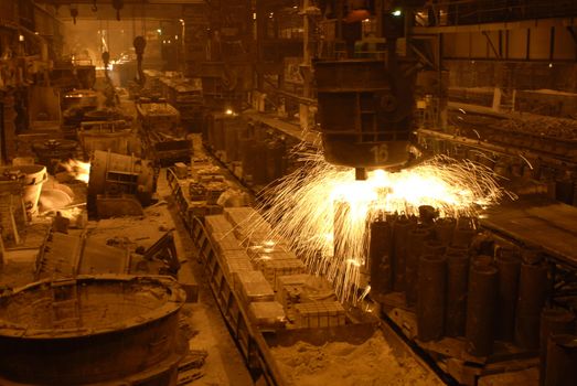 Steel-casting department of ukrainian me metallurgical works. Sparkling feeder bowl.