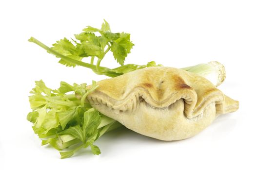 Contradiction between healthy food and junk food using celery and pasty on a reflective white background 
