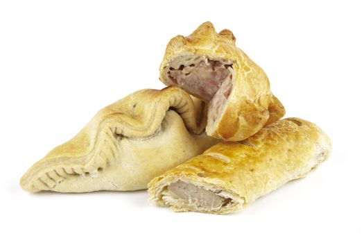 Single golden sausage roll cut in half with pork pie and pasty on a reflective white background