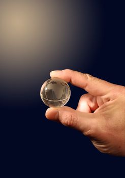 Human hand holding glass globe isolated on gradient background