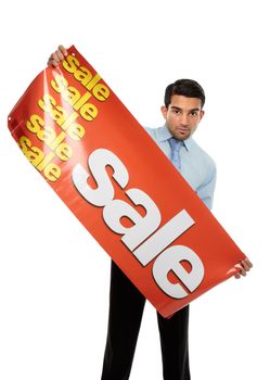 A happy excited businessman, salesman or storeperson holding a vinyl sale banner sign ready to hang.