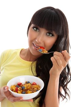 A female eating a healthy nutritional breakfast of cereals grains and fruit