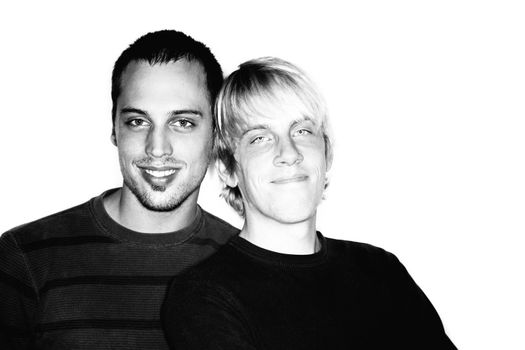 Two handsome men posing for portrait on white background