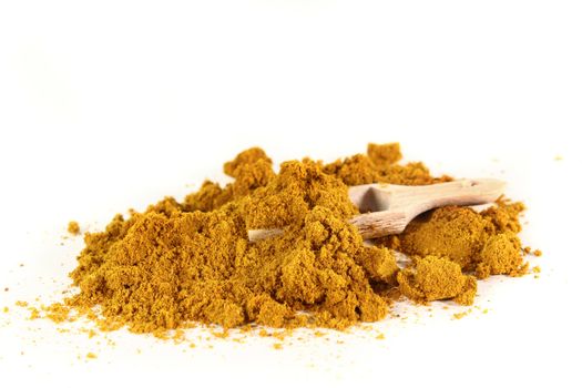 Curry powder and shovel on a white background