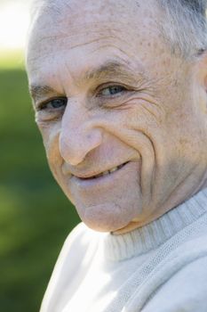 Portrait of a Smiling Senior Man Looking Directly To Camera