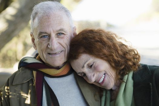Smiling Senior Couple Standing Outside in a Park