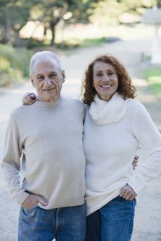 Portrait of Two Happy Seniors Holding Each Other Outdoors