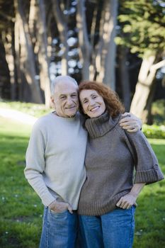 Smiling Senior Couple Holding Each Other in a Park