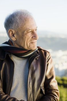 Profile of an Old Man Outdoors Wearing a  Scarf and Leather Jacket