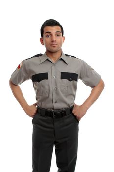 Prison guard, warden, or cop standing firm with hands on hip
