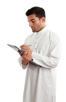 A traditionally dress middle eastern man writing in a clipboard folder.  White background.