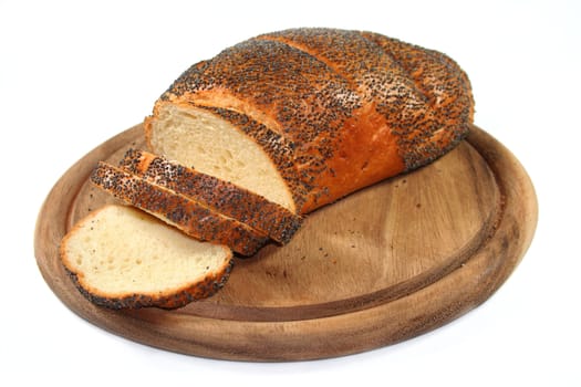 White bread with poppy seeds on a wooden board