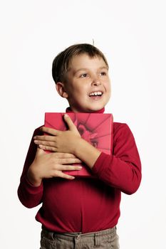 Young boy with a red gift box and looking very happy