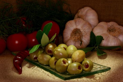 olives with olive branch and fresh ingredients