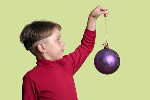 Child holding a large Christmas bauble