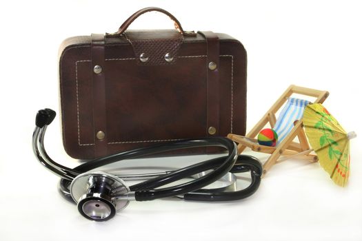 Stethoscope and suitcase on a white background