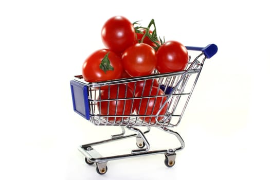 a shopping cart filled with fresh tomatoes