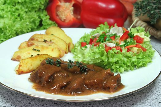 Wild thyme stew with roasted potato wedges and mixed salad