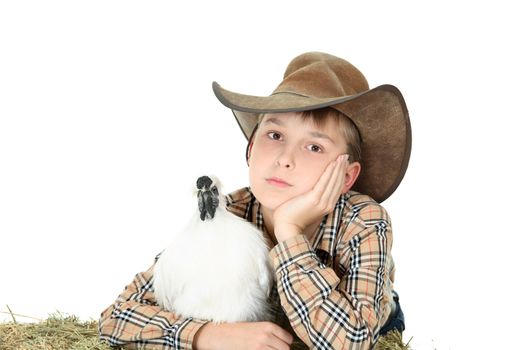 Country boy relaxing casually with a white silkie bantam. Silkie bantams are very docile and make excellent pets.  Space for copy