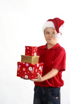 Child wearing red polo and jeans holding three gift boxes.