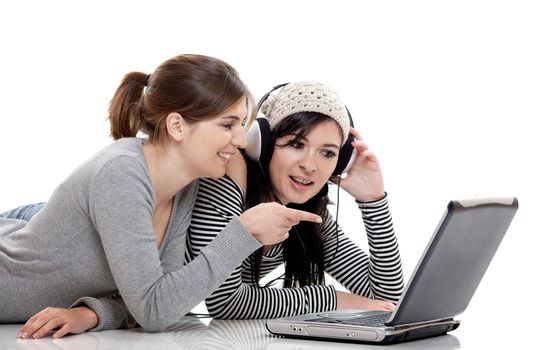 Two female young students working with a laptop