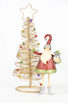 Two Christmas Decorations - Golden tree with decorative baubles and santa elf decoration on white background.