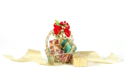 Basket of decorative gifts on white background