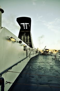 The deck of a ferryboat leaving the port of Genova in the evening light 