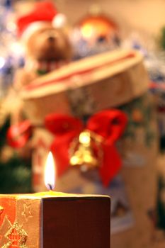 Burning candle on background with nice christmas decoration