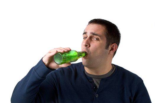 A young man drinking a bottle of beer isolated over a white background.