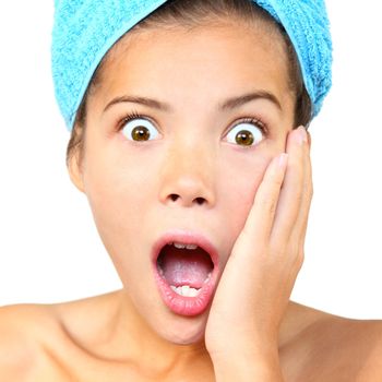 Surprised out of shower woman shocked. Closeup of Beautiful young woman model isolated on white background.