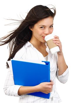 Confident smiling young businesswoman on the move drinking coffee from disposable cup. Isolated on white background.
