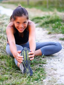 Woman stretching out during outdoor exercise in the fall. 