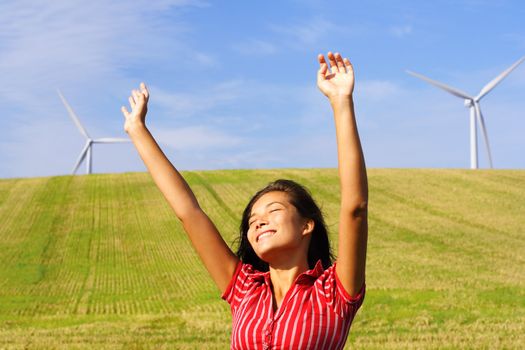 Wind turbines. Beautiful mixed race chinese / caucasian woman by wind turbines in Denmark.