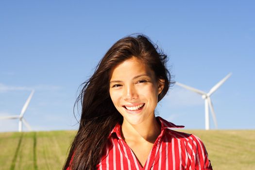 Windturbines and smiling Beautiful mixed race chinese / caucasian girl.
