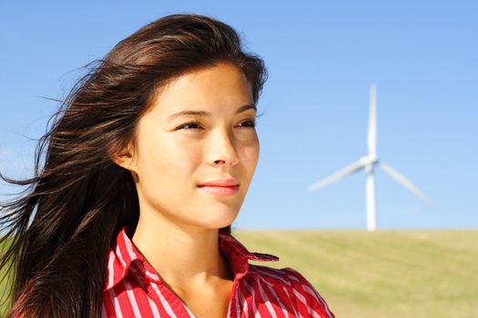 Wind turbine. Beautiful woman by wind turbine in Denmark.