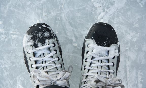 Closeup hockey ice skates in action outdoors.