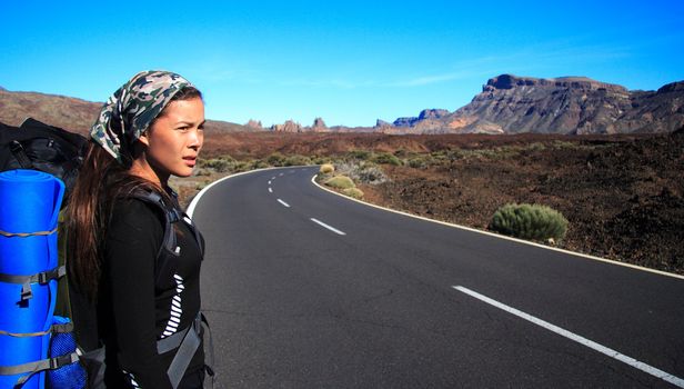 Woman traveler on the roadside on Tenerife
