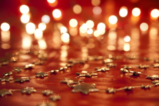Red backgroud - blurred christmas lights and golden stars. aRGB.