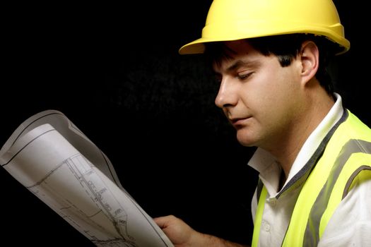 Workman or builder with architectural plans
