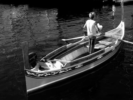 Oarsman on a traditional Malta boat known as a dghajsa