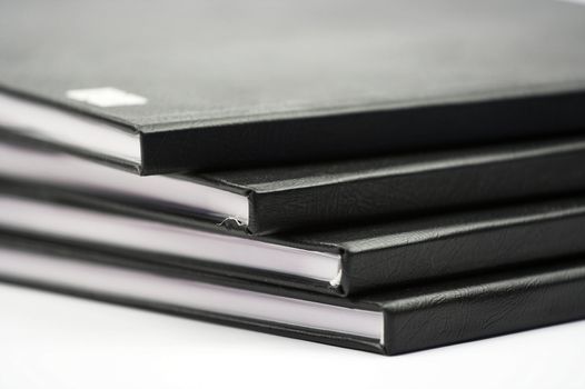 Stack of black notebooks close up