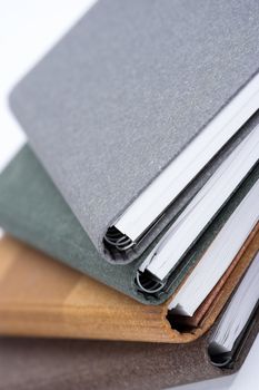 Stack of notebooks  with color cover over white