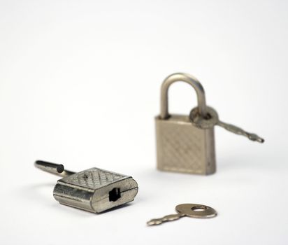 Two little padlocks and keys isolated