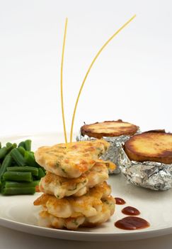 chicken cutlets, served on a plate with baked potatoes