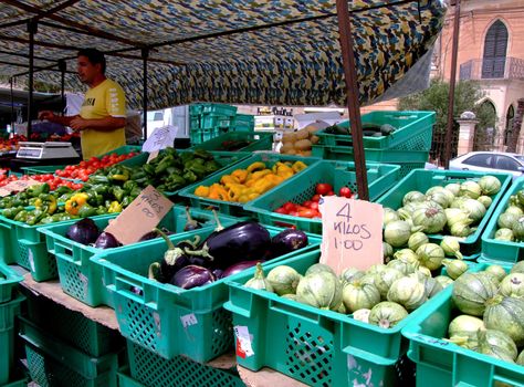 Street vendor selling fresh veg at a typical open air Mediterranean market in Malta