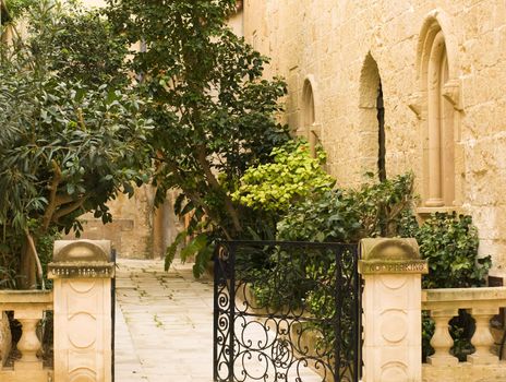 A medieval limestone facade in traditional baroque style in Mdina on the island of Malta