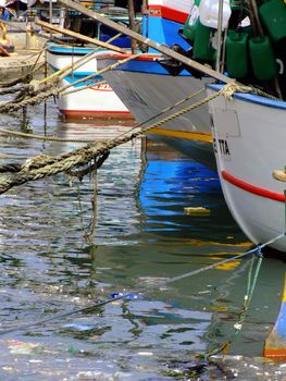 Moored yachts reflected in calm ocean waters, creating a soothing abstract effect