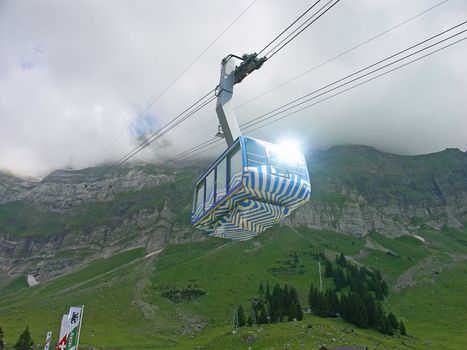 The cable car rises in mountains