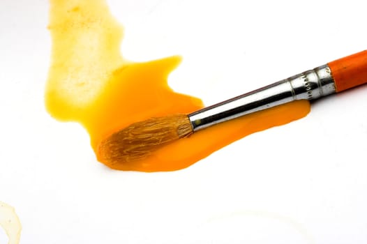 A brush  in yellow waterpaint